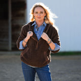 Woman wearing a brown sherpa and Ariat jeans.  Western outfit with Authentic Native American Jewelry.